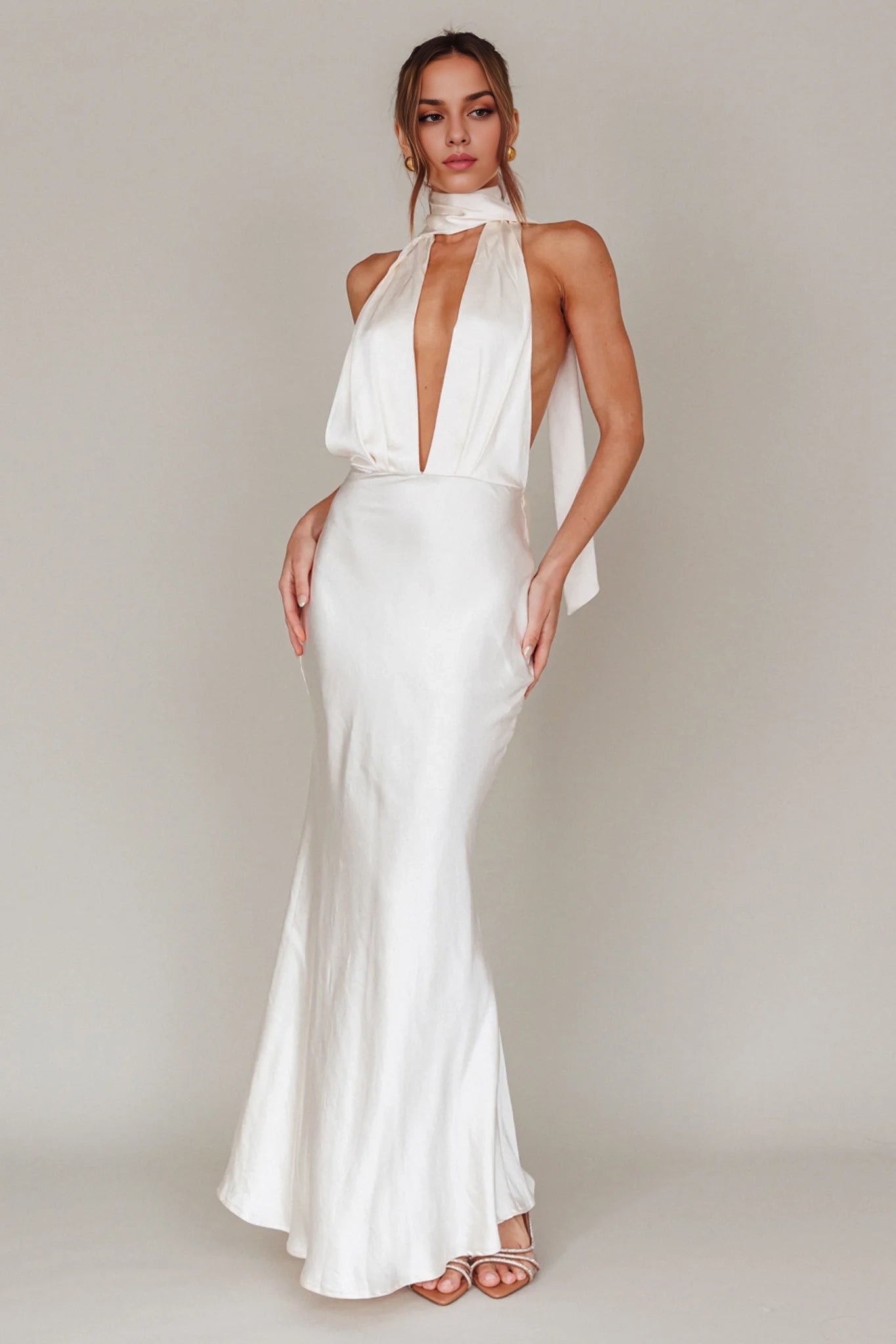 Classic backless silhouette with deep V-neck and adjustable low straps, featuring zippered sides. Homecoming Dresses