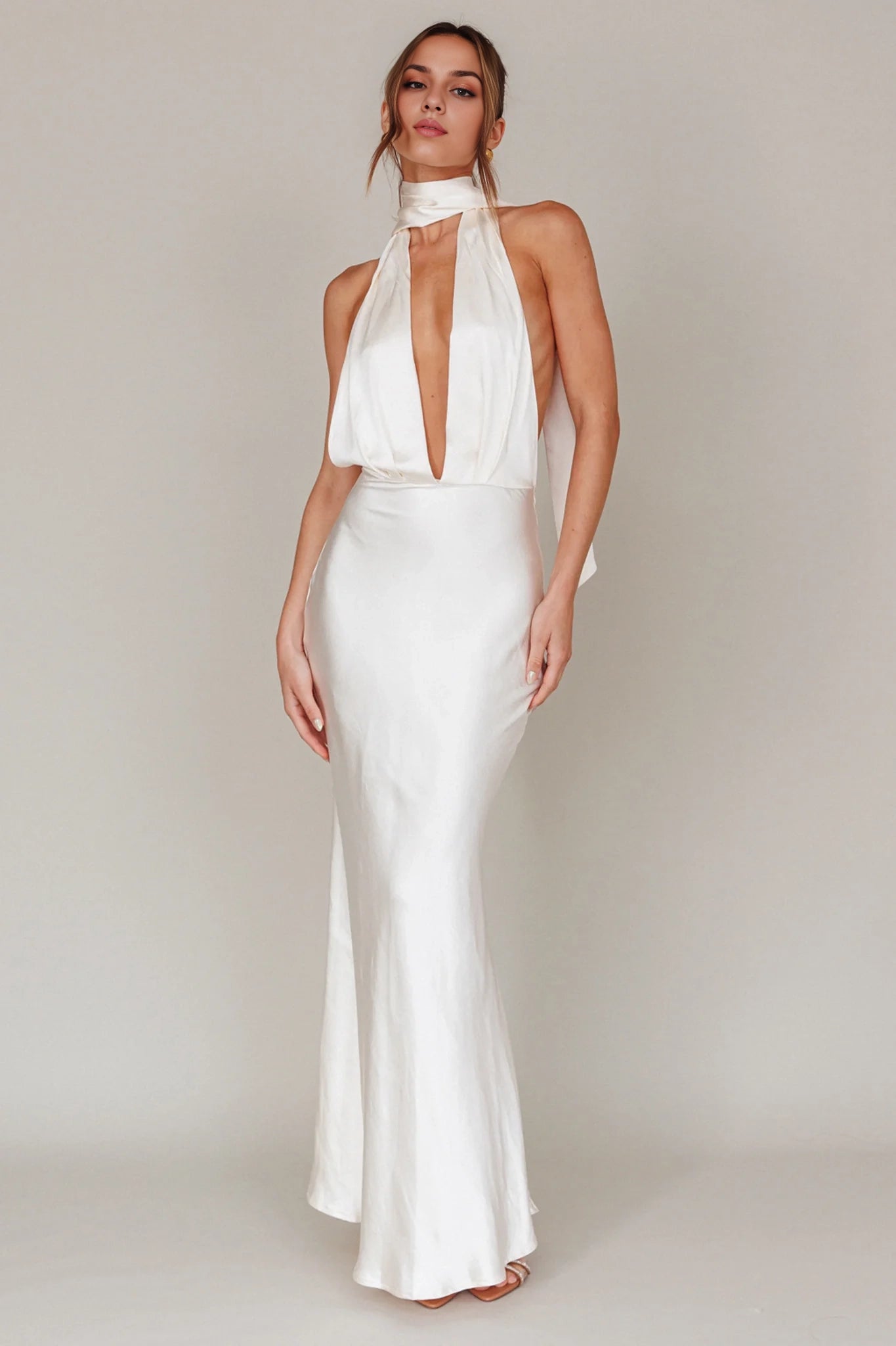 Classic backless silhouette with deep V-neck and adjustable low straps, featuring zippered sides. Homecoming Dresses