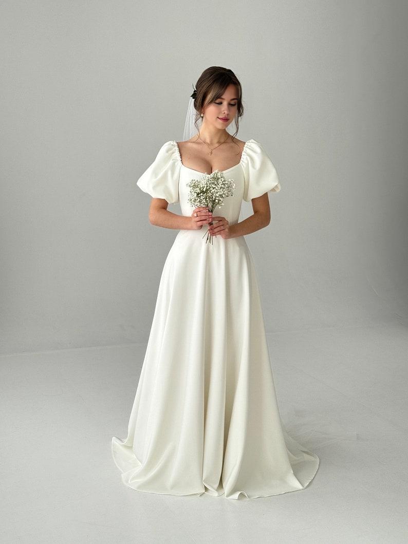 A Modest Dress With Short Sleeves An Ivory-colored Dress A Maxi Wedding Dress A Simple Wedding Dress