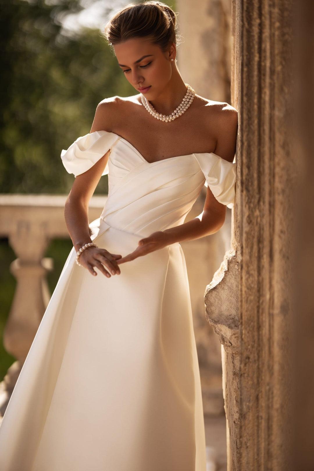 Ivory Off-Shoulder Wedding Dress with Draped Sleeves and Elegant Train