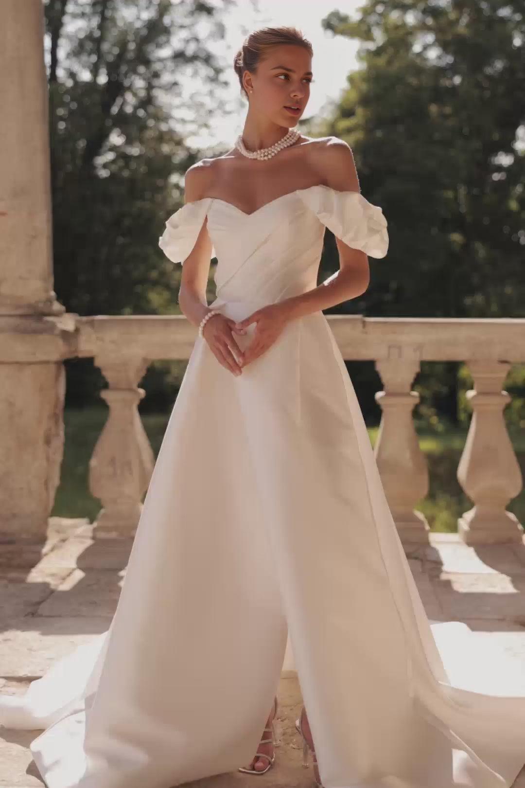 Ivory Off-Shoulder Wedding Dress with Draped Sleeves and Elegant Train