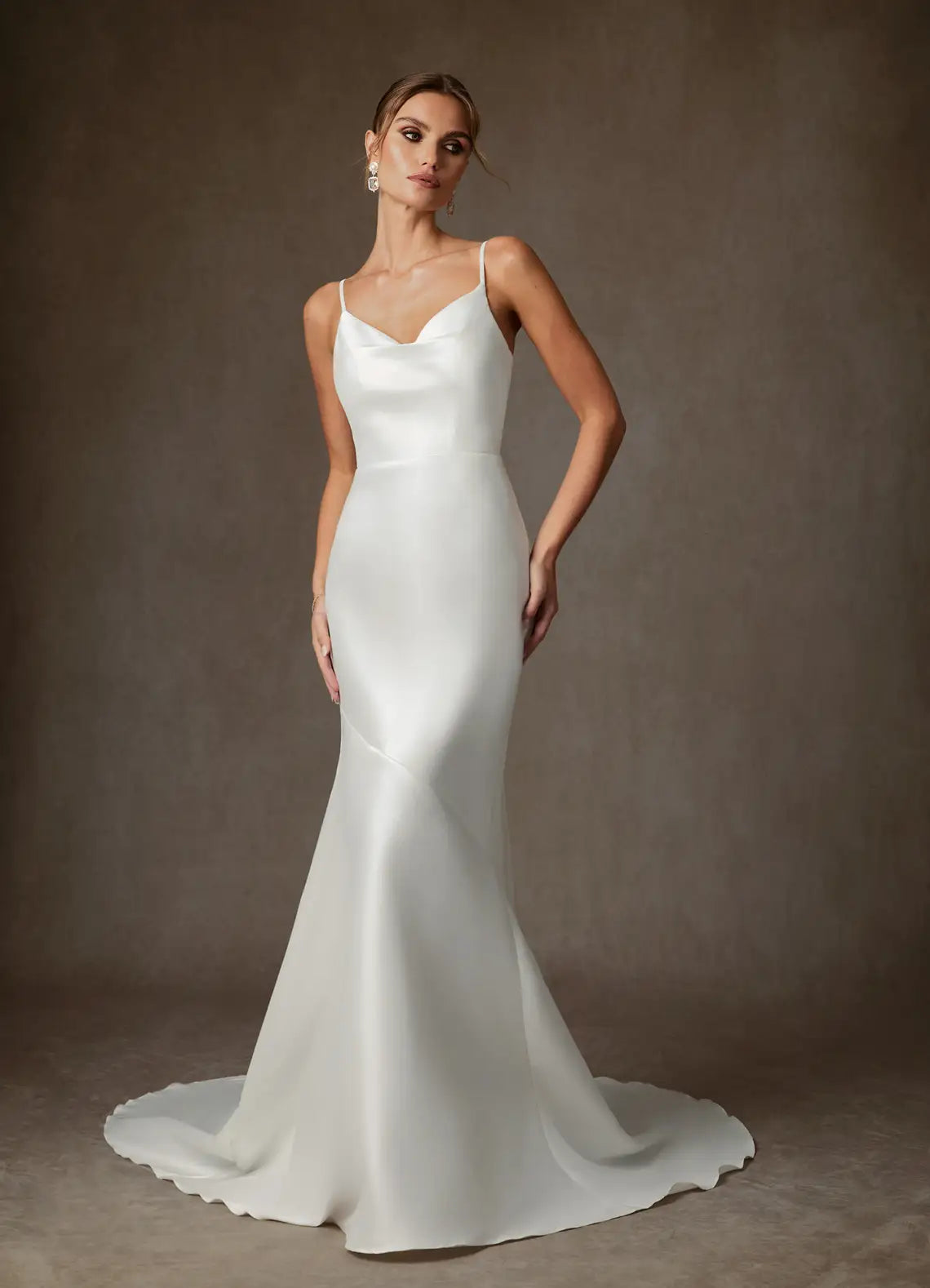 Luxurious smooth satin constructionElegant satin mermaid gown featuring a cowl neckline, thin spaghetti straps, and a dramatic bow back detail.Satin Cowl Neck Mermaid Wedding Dress with Bow Back