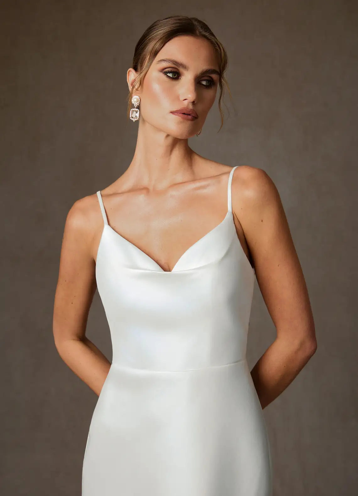 Luxurious smooth satin constructionElegant satin mermaid gown featuring a cowl neckline, thin spaghetti straps, and a dramatic bow back detail.Satin Cowl Neck Mermaid Wedding Dress with Bow Back