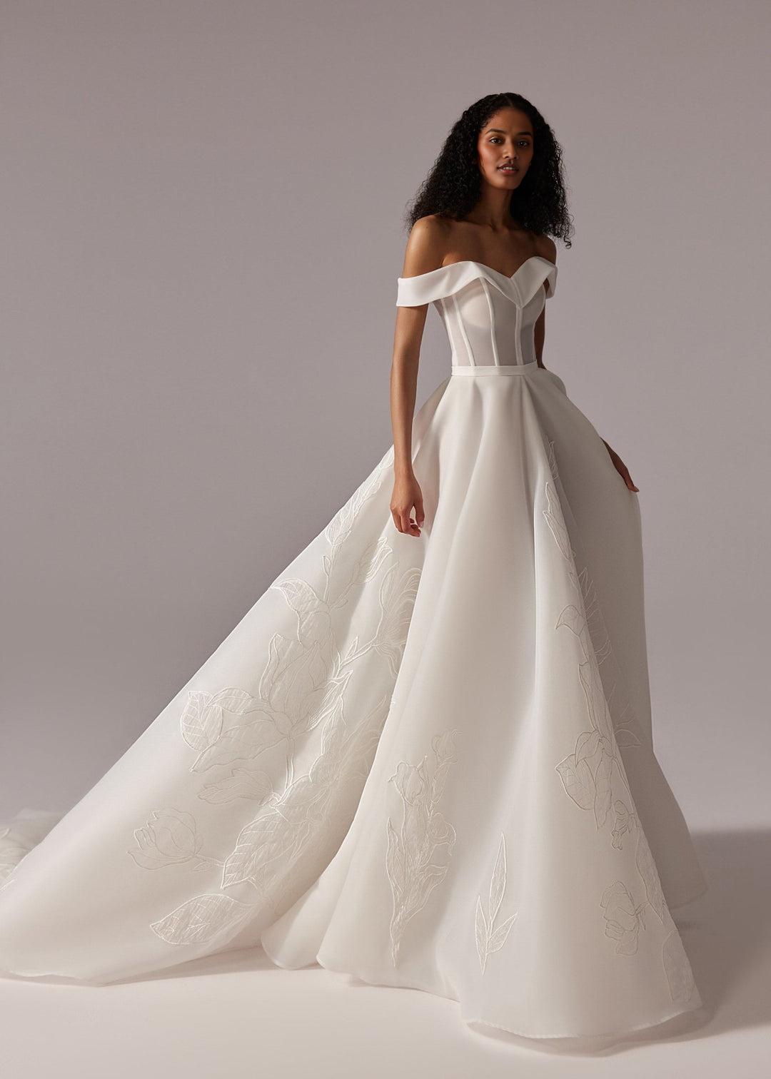 White Off-Shoulder Ball Gown Wedding Dress with Embroidered Skirt and Dramatic Train