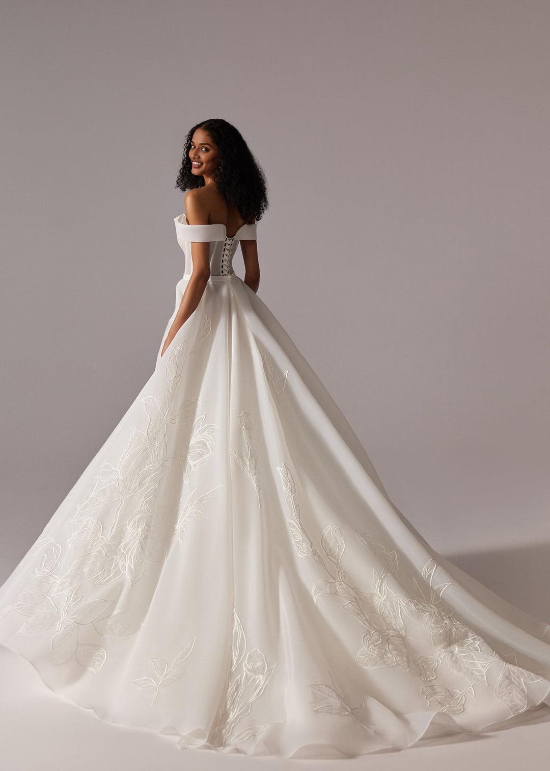 White Off-Shoulder Ball Gown Wedding Dress with Embroidered Skirt and Dramatic Train