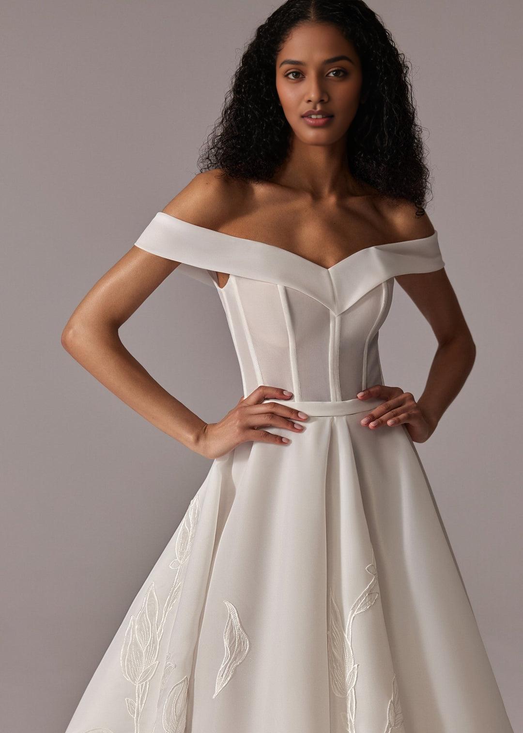 White Off-Shoulder Ball Gown Wedding Dress with Embroidered Skirt and Dramatic Train